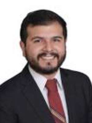 person in suit with red tie, face blurred on white background
