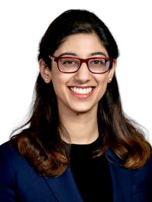 Head shot of Radhika Rawat in business attire, smiling at the camera