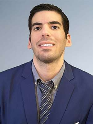 Headshot of Dr. Essam Assali in a blue suit
