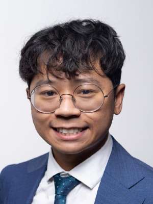 headshot of Timothy Nguyen in blue suit