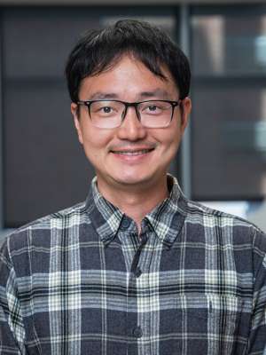 Headshot of Doctor Jijun Huang in a flannel shirt