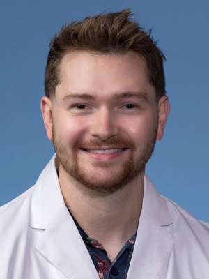 Nick Sengbush, DO in a white lab coat