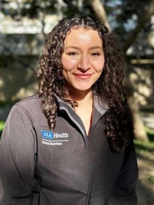 a headshot of Tatiana Romero wearing a grey UCLA Health jacket