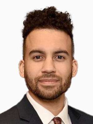 Jared Taitt portrait in suit and tie on white background.