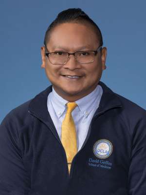 Ronald Gonzalez in a dark blue UCLA jacket and gold tie