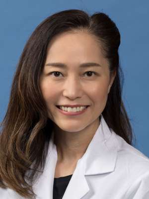 Julie Kim, MD in a white lab coat