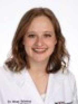 Head shot of Miriam Salamon in white lab coat, smiling at camera