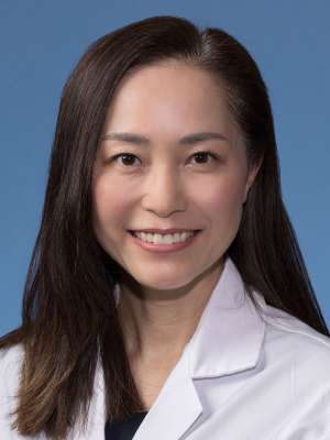 Julie Kim, DO, MS in a white lab coat