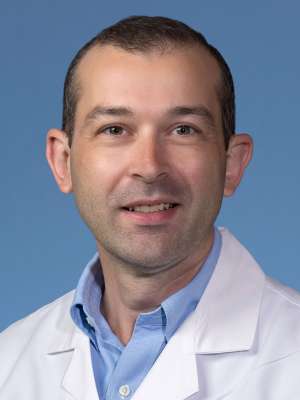 Hayk Simonyan, MD in a white lab coat