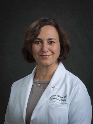 Armine Baltayan, MD in white lab coat with dark background