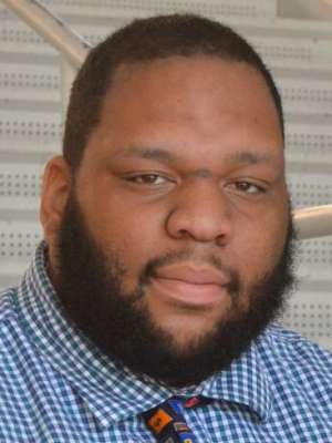 headshot of Anthony jones in a blue plaid shirt