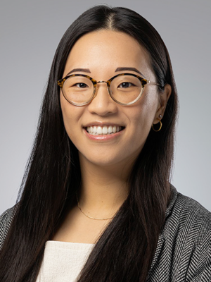 Head shot of Joyce Lee in business attire, smiling at the camera