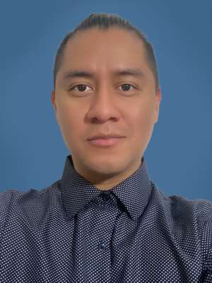 headshot of Rolando Kok in polka-dot button-down shirt