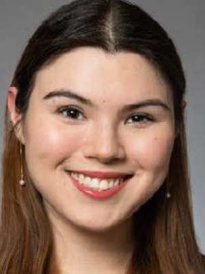  Headshot of Natalie Gault, a young woman with long, straight, brown hair, smiling sincerely at the camera.