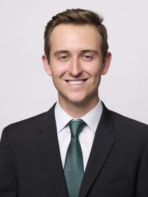 Head shot of Dr. Brendan Colgan in a suit, smiling at the camera