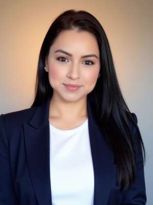 Fabiola Martinez with long dark hair in navy blazer and white top