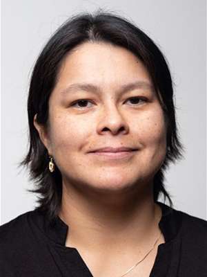 headshot of Sara Flores in black blouse