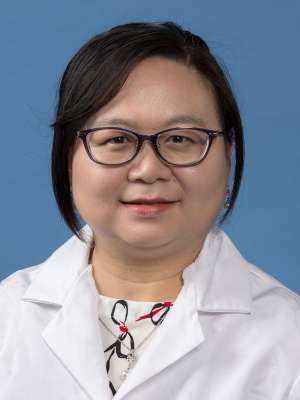 Chao Chen, MD, PhD, in a white lab coat