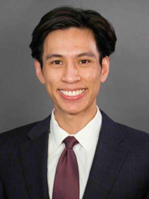 headshot of Dr. Michael Le in a dark suit
