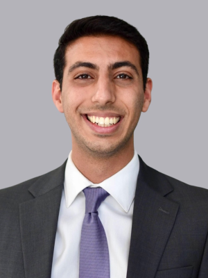 Jonathan Massachi, MD wearing a gray suit jacket, white shirt, grey tie