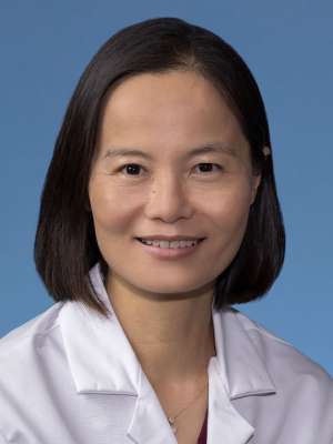 Chenchen Niu, MD in a white lab coat