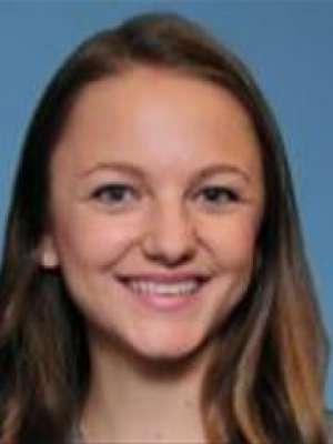 headshot of Dr. Rebecca Nayeri with a blue background