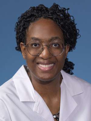 Bettie Yeboah, MD, MS in a white lab coat