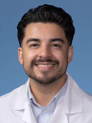 Pablo Alvarez, PhD in a white lab coat