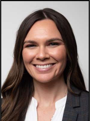 headshot of Alyssa Anderson wearing a white blouse and black blazer in front of a white background