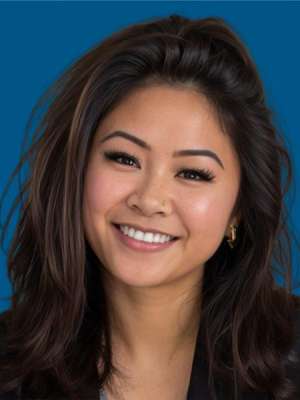 headshot of Karmel Bas with a blue background