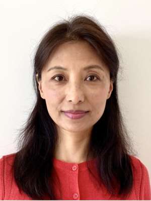 headshot of Lucy Shah in red sweater