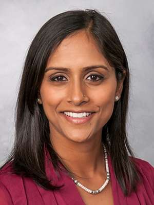 headshot of Nikita baclig in burgundy blouse