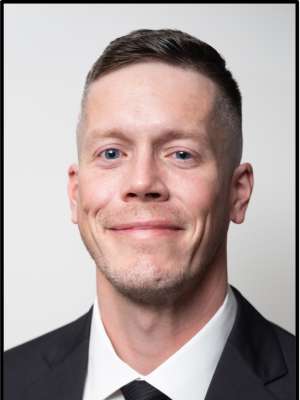 headshot of Jordan Steelquist wearing a black suit in front of a white background