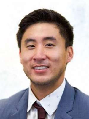 headshot of Christopher Lee in blue suit