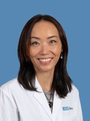Dr. Susan Leonard smiling in white coat.