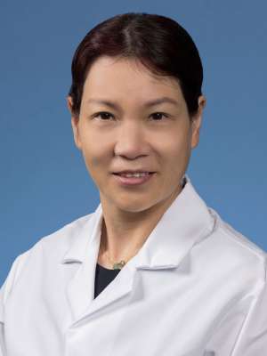 Qiuheng Jennifer Zhang, PhD in a white lab coat