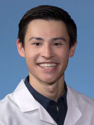Jacob Hum, MD in a white lab coat