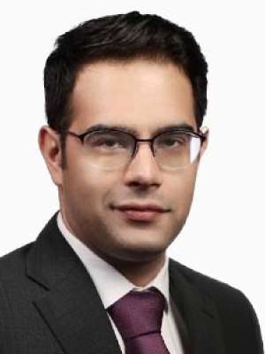 Headshot of Mohammad swearing a black suit with maroon tie