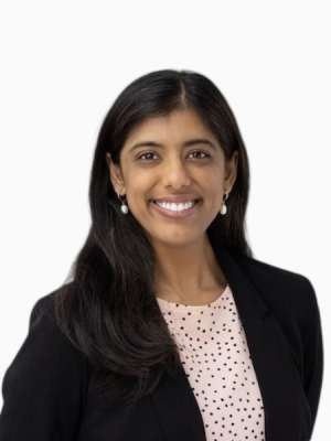 Shilpa Rajagopal smiling, wearing black blazer and polka-dot blouse