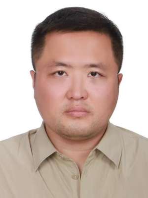 Xiaoqing Song headshot, wearing a khaki button up shirt.
