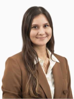 Woman in brown blazer smiling at camera
