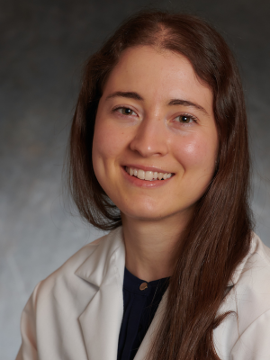 professional headshot of Kristin Boulier, MD in a white lab coat, in front of a gray background