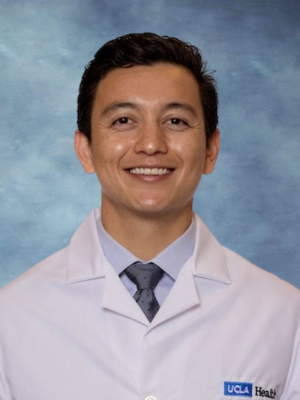 A headshot of a Dr. Michael LoBasso with dark hair, and a warm smile, wearing a white coat and a tie.