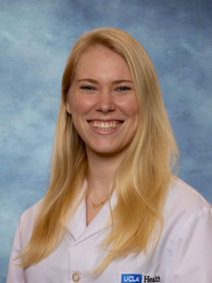 Dr. Fiona Roediger headshot smiling and wearing a white lab coat.