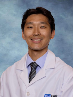 headshot of Dr. Christopher Yoon wearing a labcoat in front of a blue background