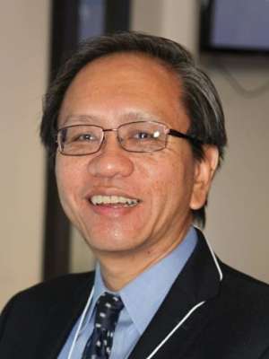Headshot of Guy Soo Hoo, MD, smiling, in a dark suit and tie.