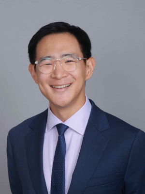 Head shot of Jerry Shen in business attire, smiling at camera