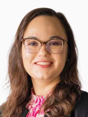 Emma E. Williams MD headshot smiling with glasses and blazer