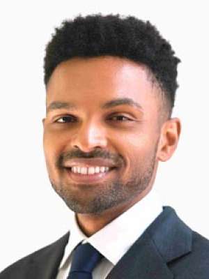 Professional headshot of Jarrod Moore smiling in a suit and tie.