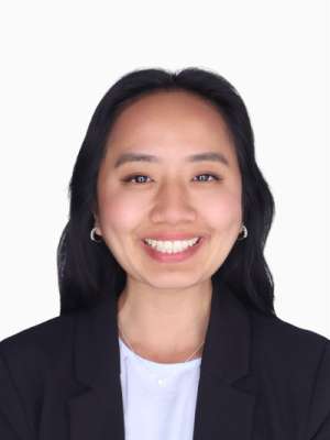 Elizabeth Sun smiling headshot in blazer on white background